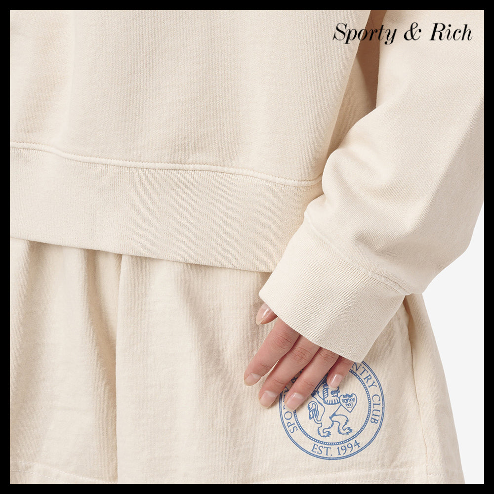 【SPORTY & RICH】ライオンクレストポロシャツ