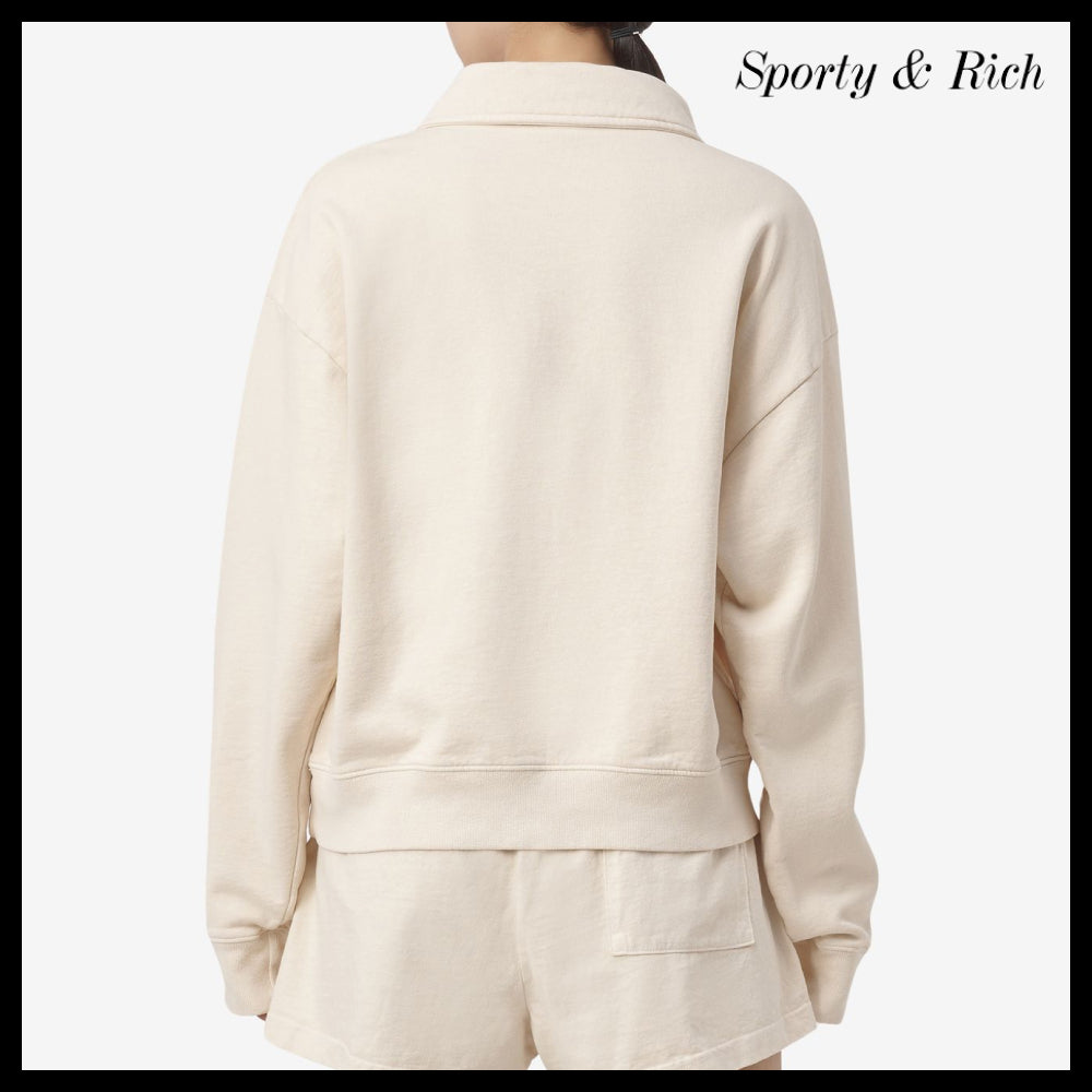 【SPORTY & RICH】ライオンクレストポロシャツ
